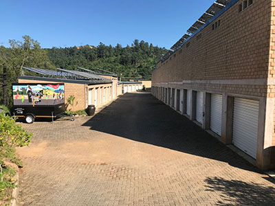 A van and bakkie being loaded outside open storage units at Giba Storage